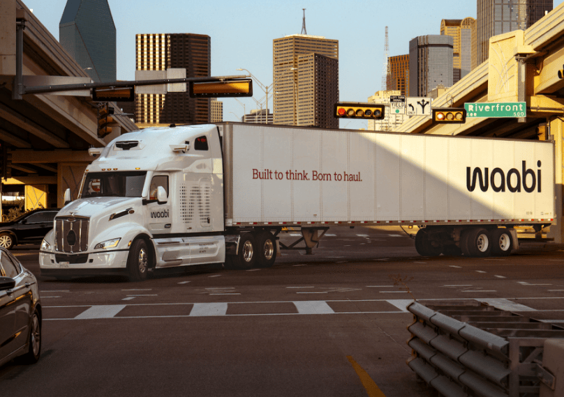 Autonomous Waabi self-driving truck operating on an urban roadway, highlighting AI-powered freight transportation technology.