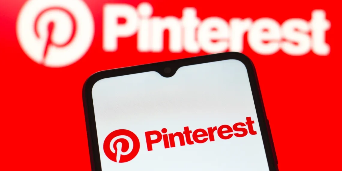 Pinterest logo displayed on a smartphone screen with the Pinterest brand logo in the background, representing the platform’s role in digital search and discovery.