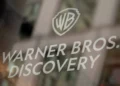 Warner Bros. Discovery logo displayed on a glass surface, representing the global media and entertainment company.
