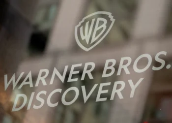 Warner Bros. Discovery logo displayed on a glass surface, representing the global media and entertainment company.
