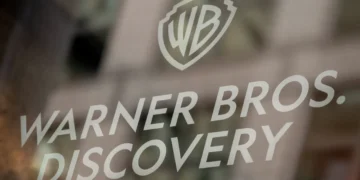 Warner Bros. Discovery logo displayed on a glass surface, representing the global media and entertainment company.